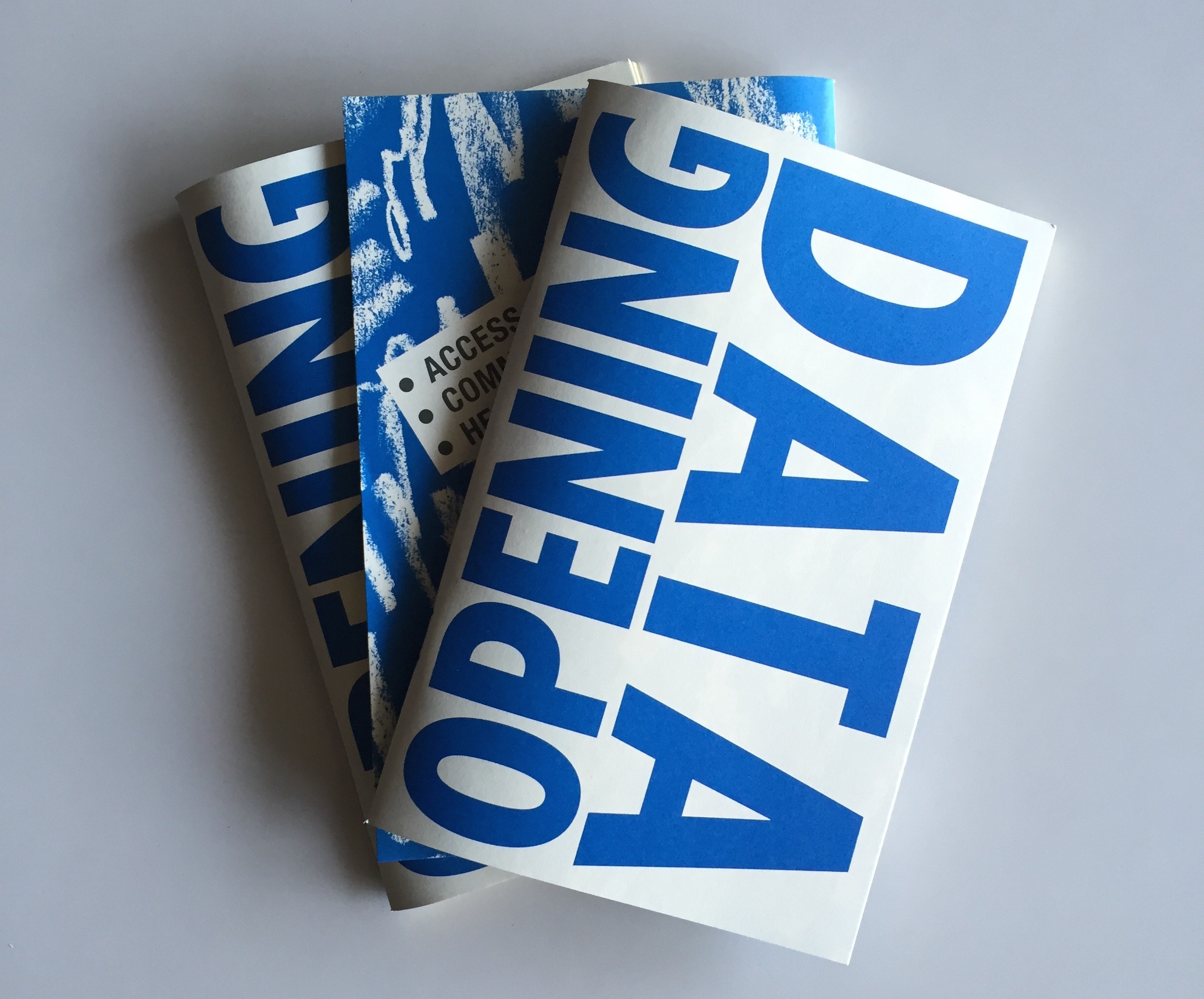 Opening Data Zine by DCTP and the Detroit Digital Justice Coalition. Image description: Three zine printouts stacked on top of each other. The one on top reads “opening data” in big, bold, cyan capital letters in a sans serif font.