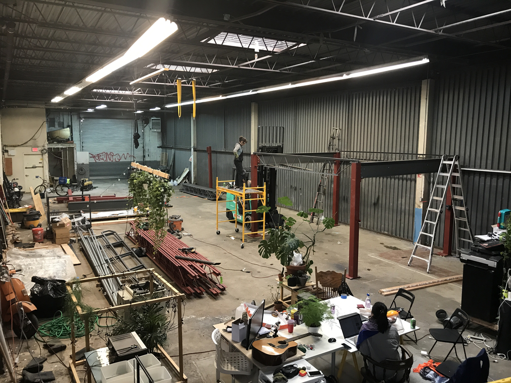 Soft Surplus members collectively building the mezzanine at their studio space.
